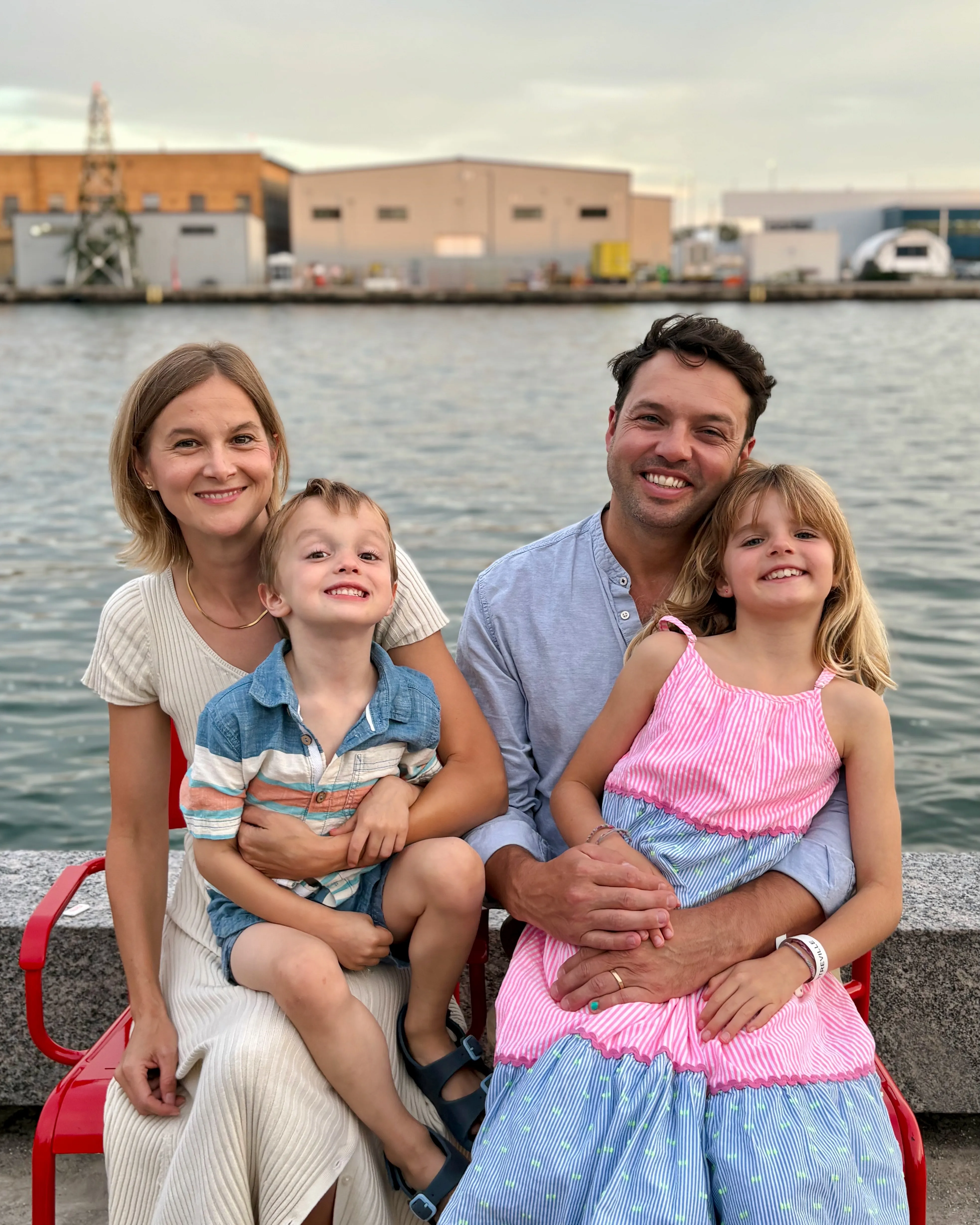 Laura Dean with her husband and two young children on a bench at the Toronto waterfront